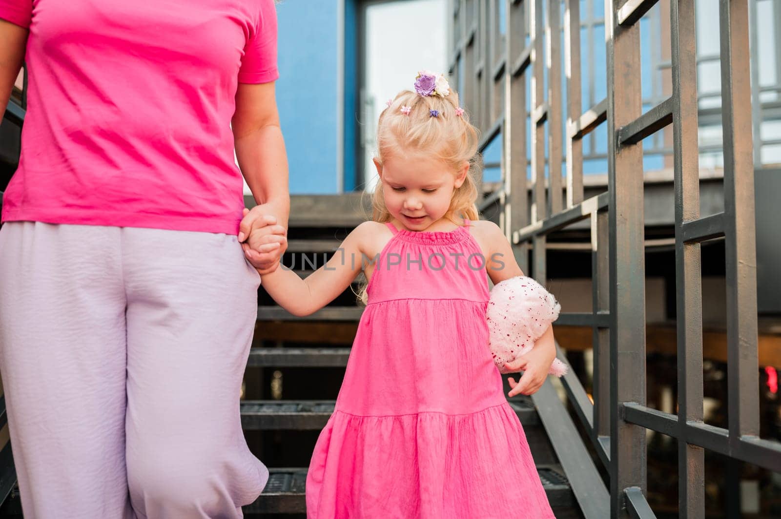 Child with hearing problem and cochlear implant plays in street, deaf kid began to hear. Hearing loss in childhood and treatment concept. Inclusion and disability. by Satura86