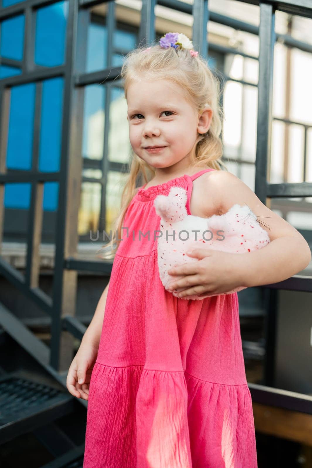 Child girl with hearing aids and cochlear implants having fun outdoor speak and playing. Copy space and empty place for advertising.