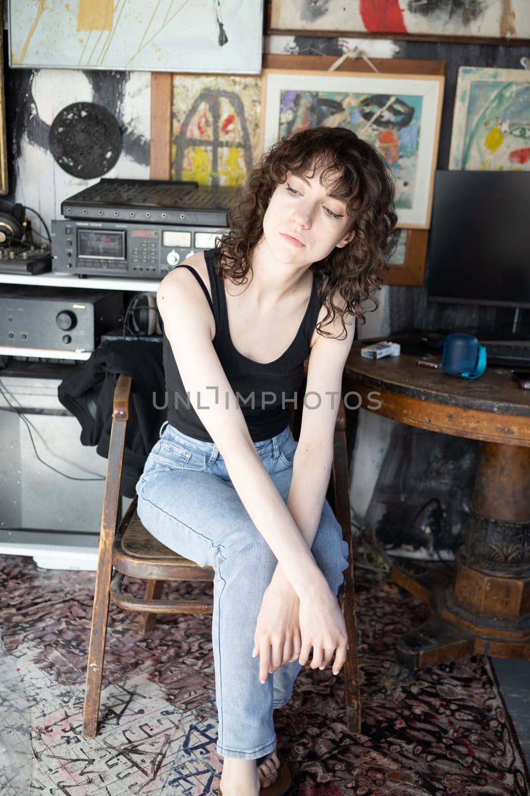 young beautiful woman posing in blue jeans in studio