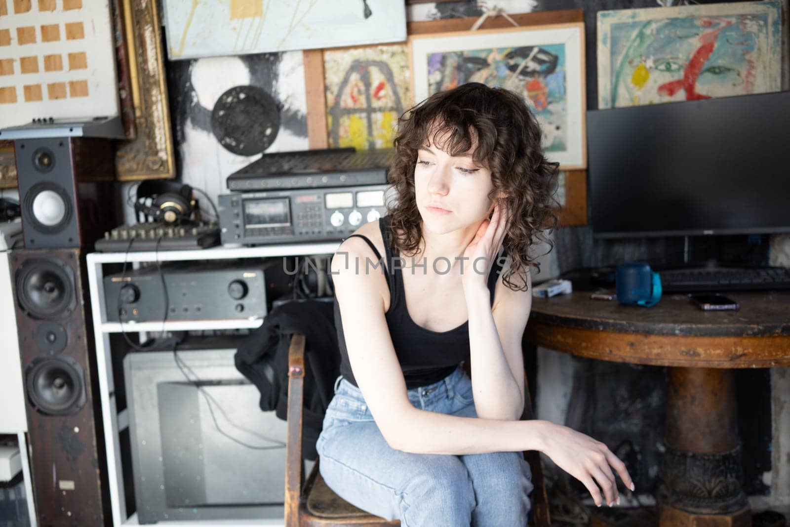 young beautiful woman posing in blue jeans in studio