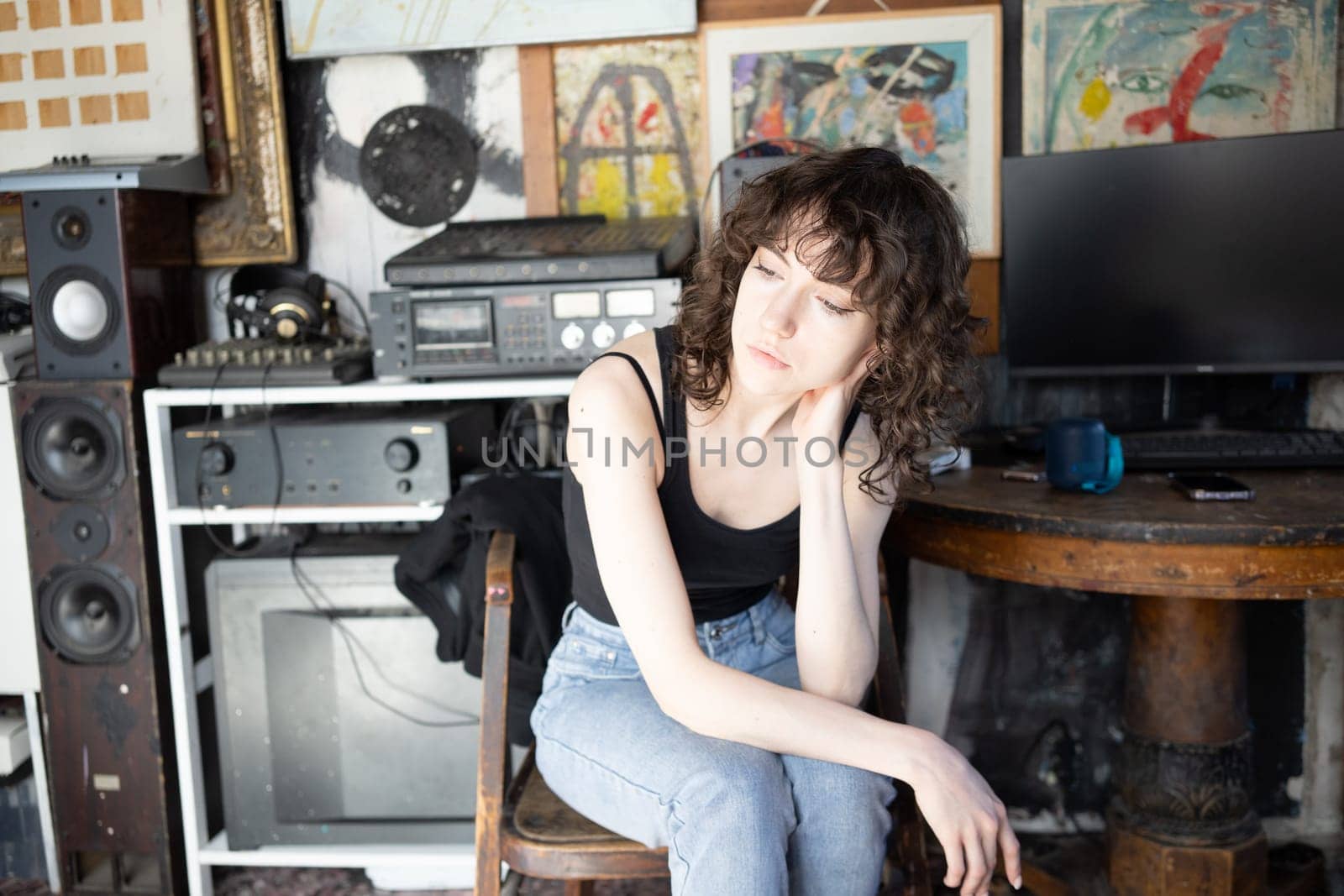 young beautiful woman posing in blue jeans in studio