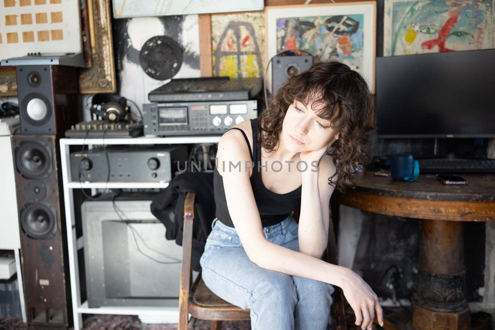 young beautiful woman posing in blue jeans in studio