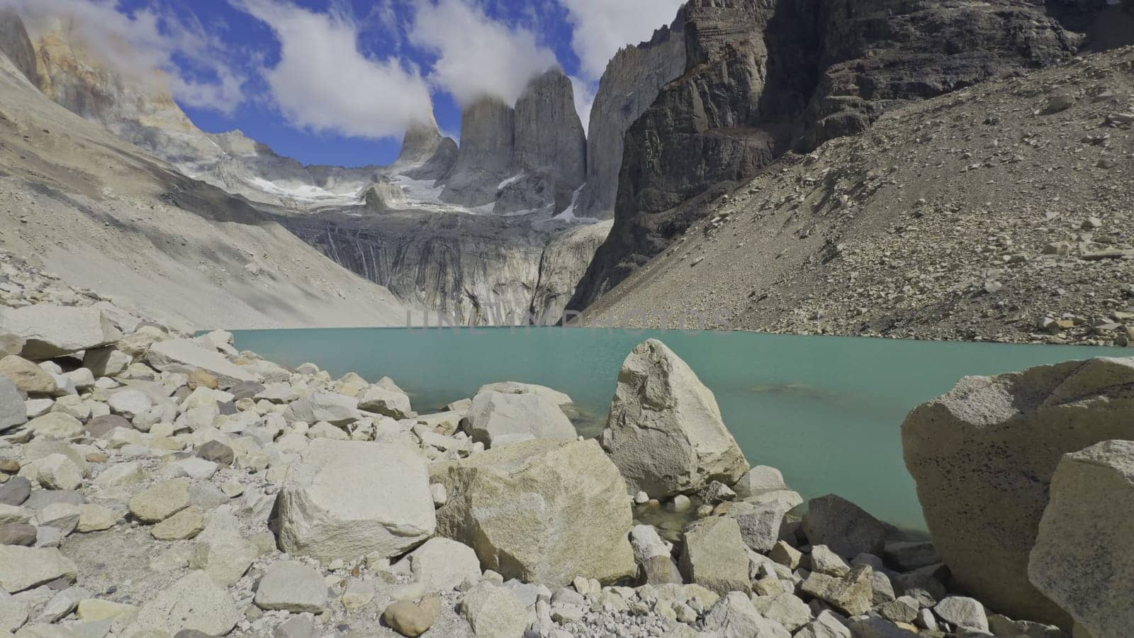 Scenic video of a turquoise lake with the majestic Torres del Paine in the background, devoid of any people.