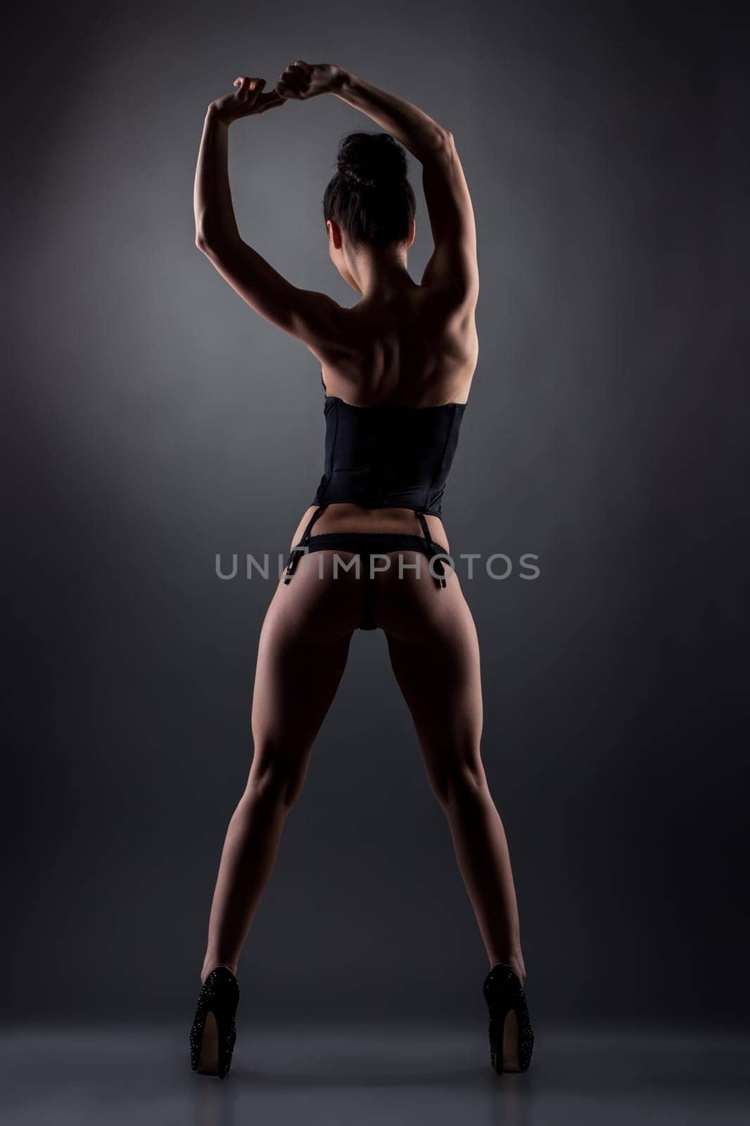 Erotica. Back view of slender leggy girl in underwear