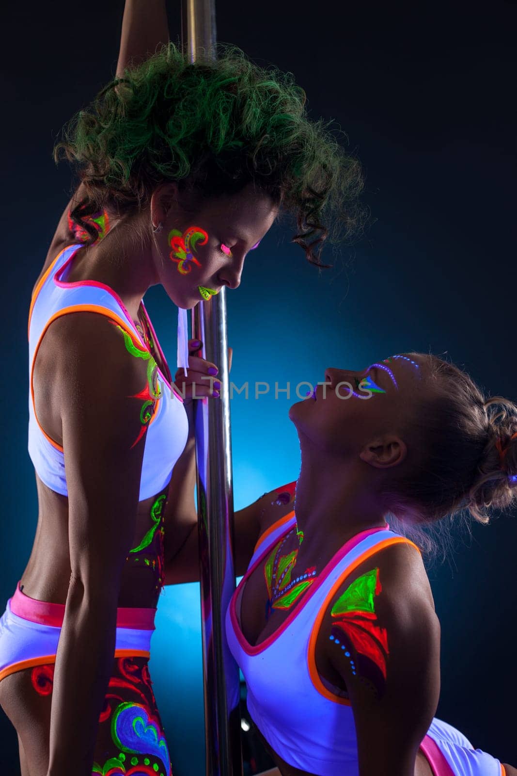 Image of artistic dancers with bright glowing bodyart