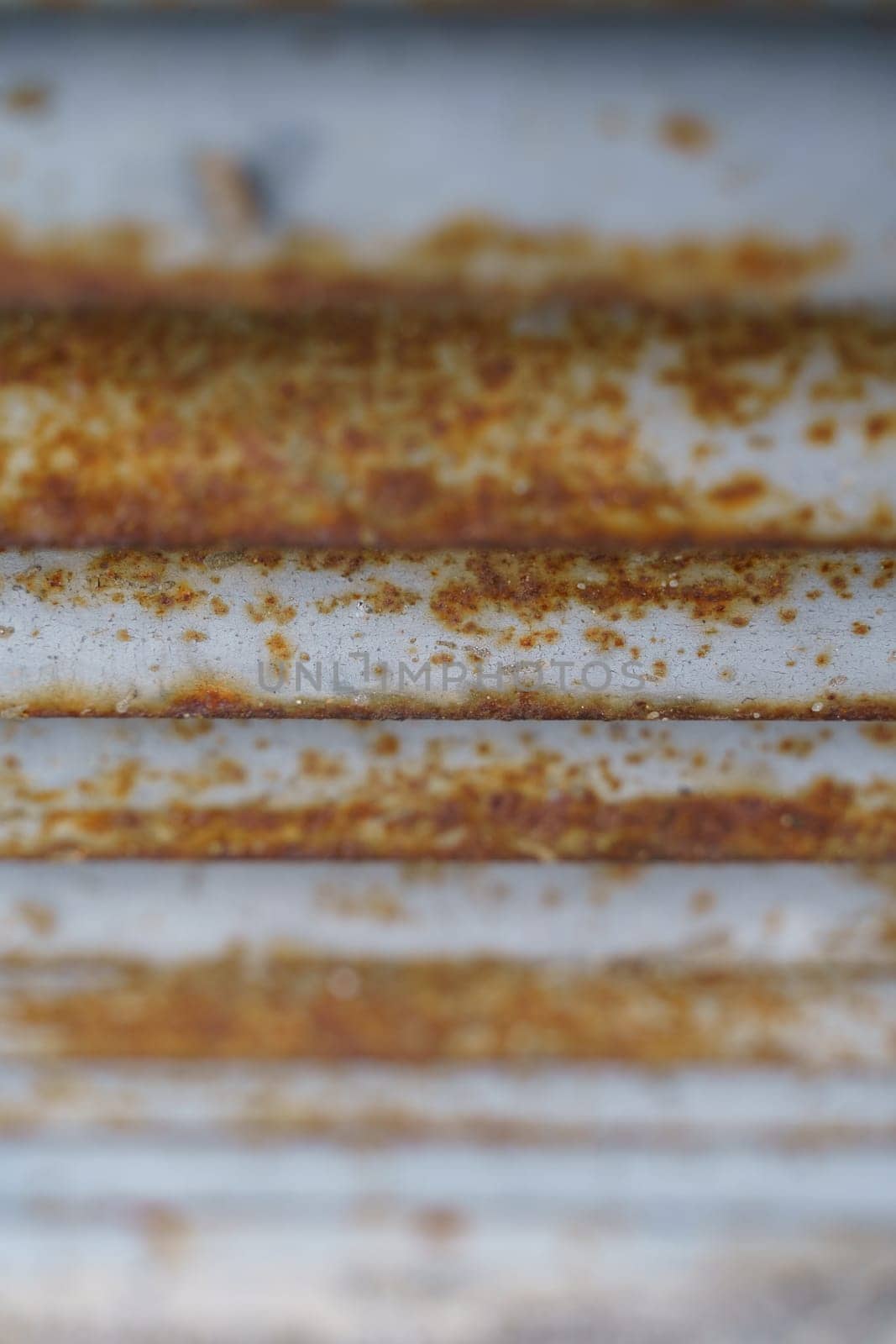 Macro shot of a weathered and rusted metal surface, showcasing intricate patterns and textures formed by oxidation.