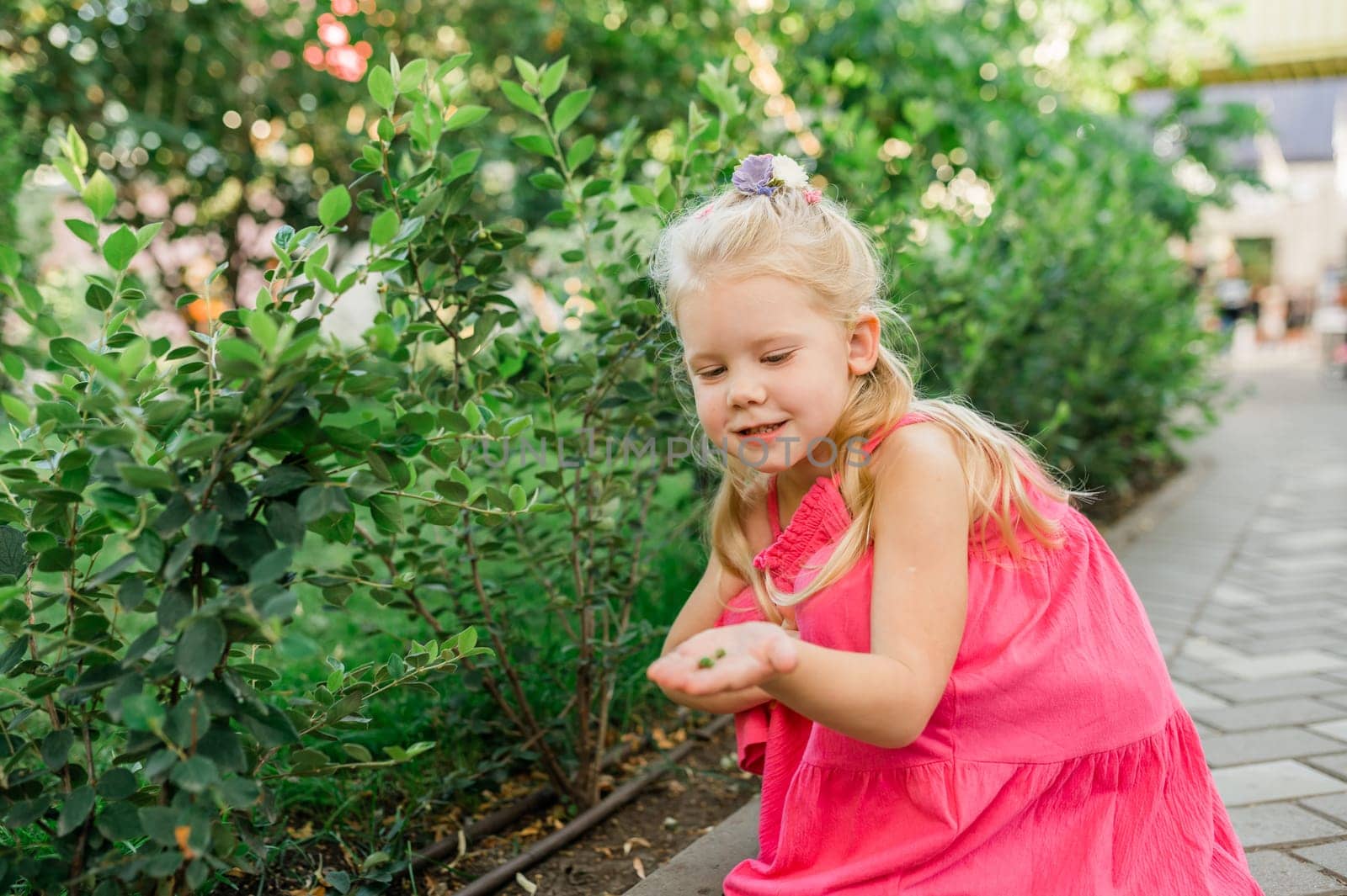 Funny baby with cochlear implant walks outdoor. Hearing aid and medicine innovating technology concept. Diversity and inclusion. Copy space.