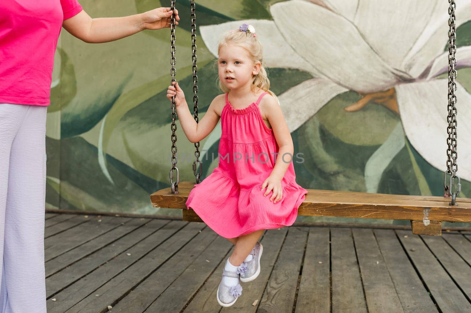 Child girl with hearing aids and cochlear implants having fun outdoor speak and playing. Inclusion and disability. by Satura86