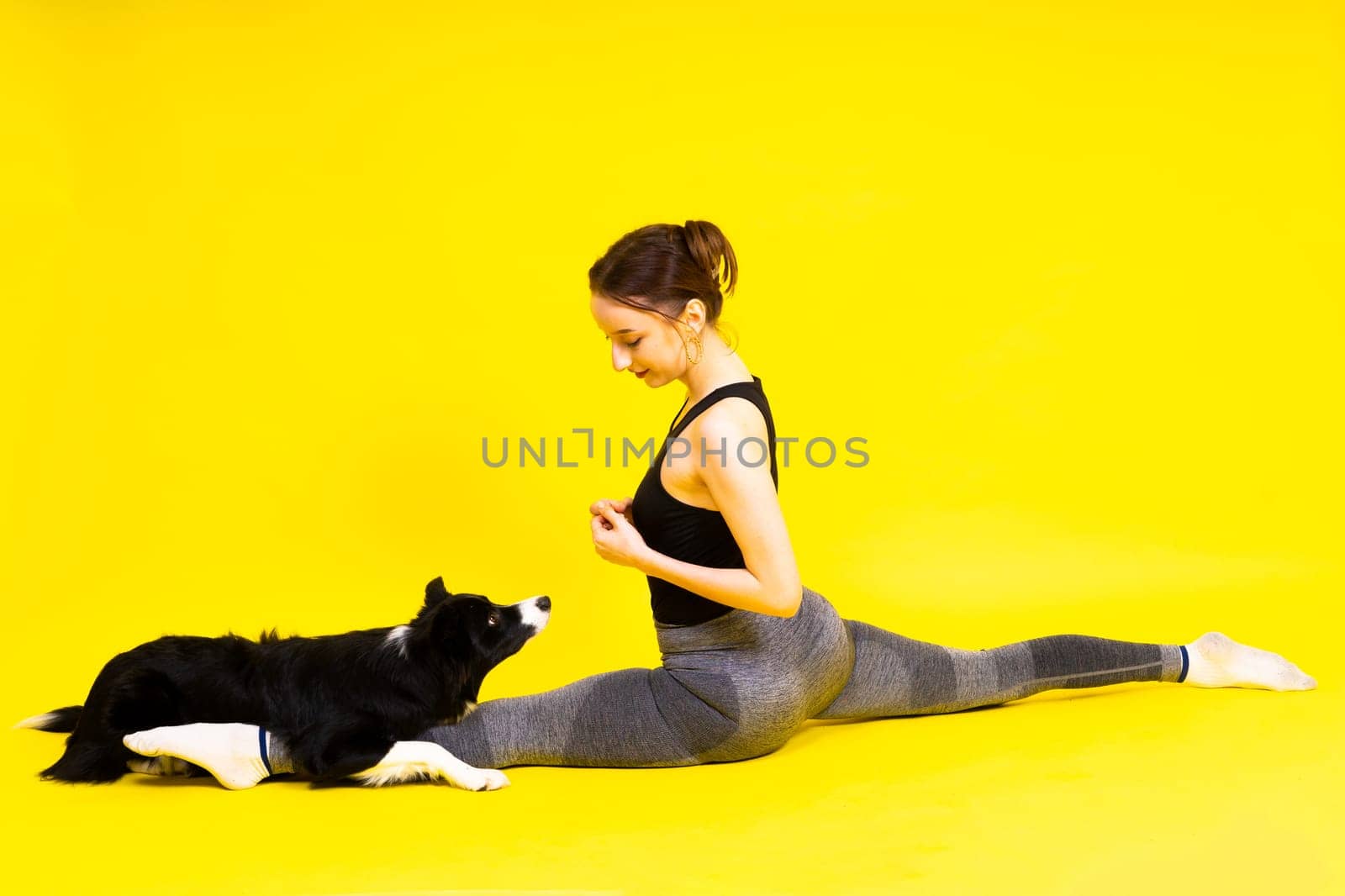 Beautiful sport female with border collie in studio by Zelenin