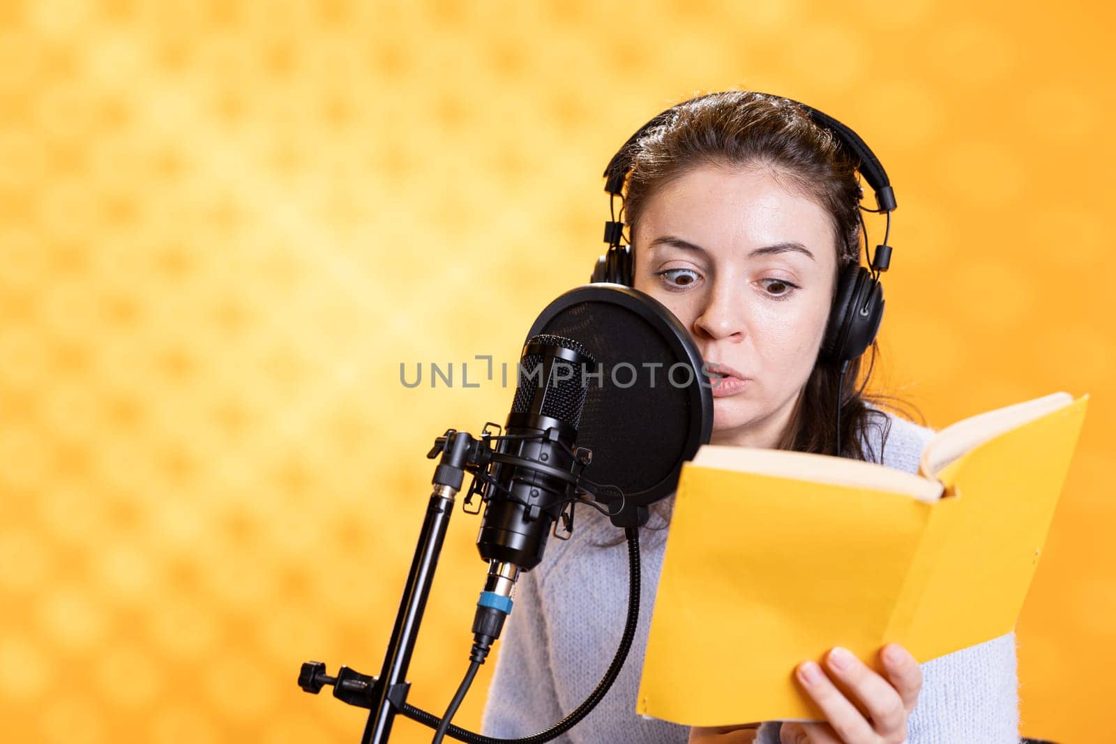 Narrator with shocked look on face recording horror audiobook, studio background by DCStudio