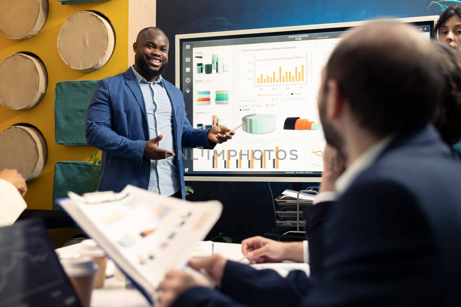 Sales representative examine financial reports and success metrics with archived infographics, looking for corporate expansion opportunities. Training to become a multinational organization.