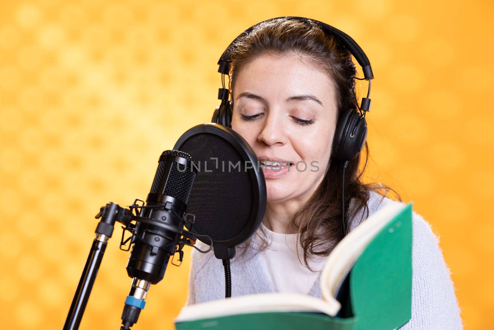 Happy voice actor using storytelling skills to produce audiobook by DCStudio