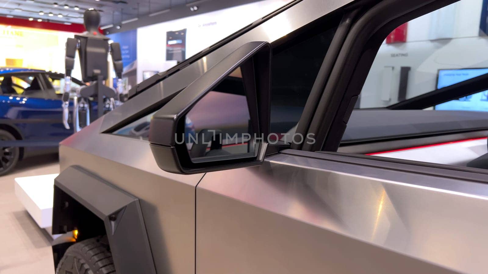 Colorado Springs, Colorado, USA-March 23, 2024-The futuristic Tesla Cybertruck takes center stage in the showroom of a Tesla store, with interested visitors and sleek car designs in the backdrop, all within the Park Meadows Mall.