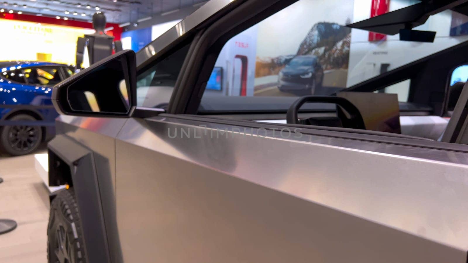 Colorado Springs, Colorado, USA-March 23, 2024-The futuristic Tesla Cybertruck takes center stage in the showroom of a Tesla store, with interested visitors and sleek car designs in the backdrop, all within the Park Meadows Mall.