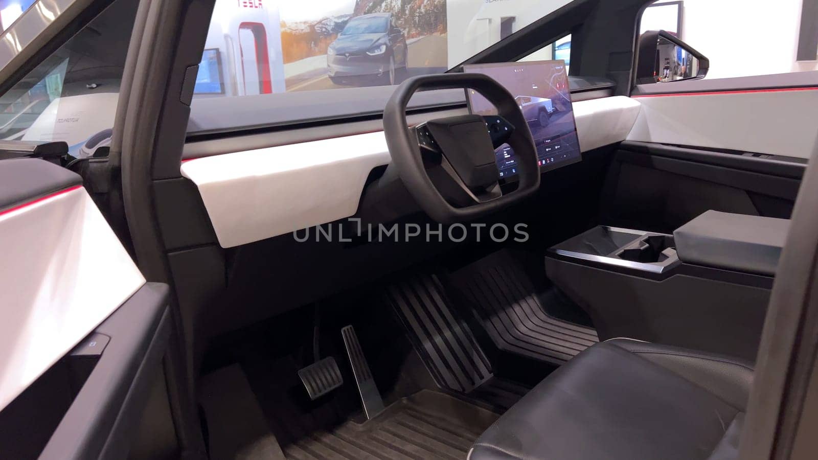 Colorado Springs, Colorado, USA-March 23, 2024-The futuristic Tesla Cybertruck takes center stage in the showroom of a Tesla store, with interested visitors and sleek car designs in the backdrop, all within the Park Meadows Mall.