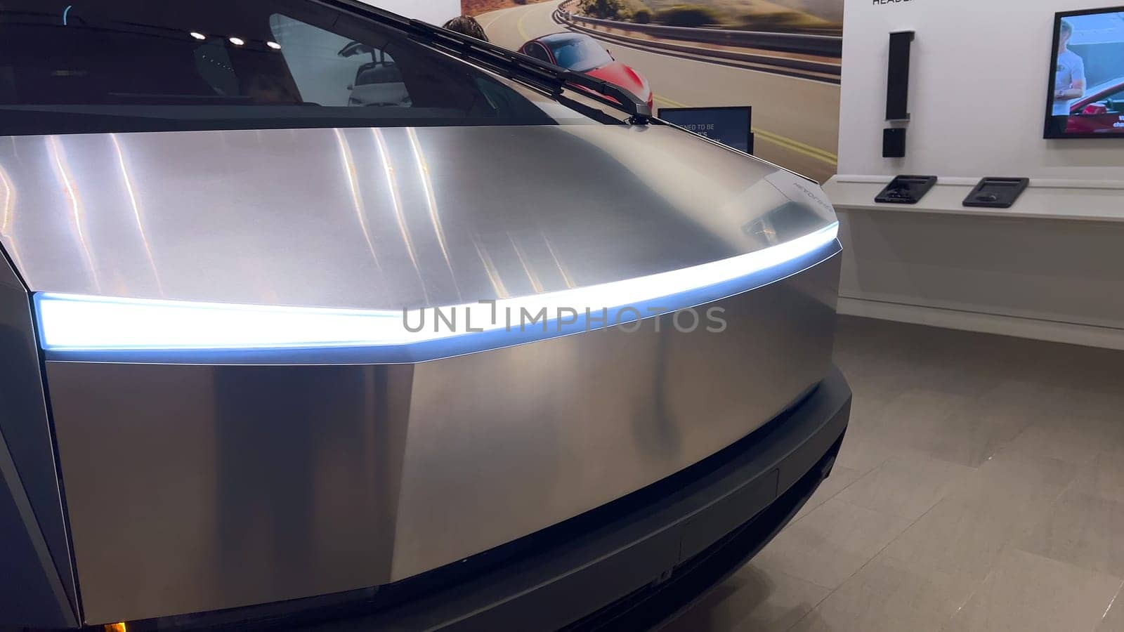 Colorado Springs, Colorado, USA-March 23, 2024-The futuristic Tesla Cybertruck takes center stage in the showroom of a Tesla store, with interested visitors and sleek car designs in the backdrop, all within the Park Meadows Mall.