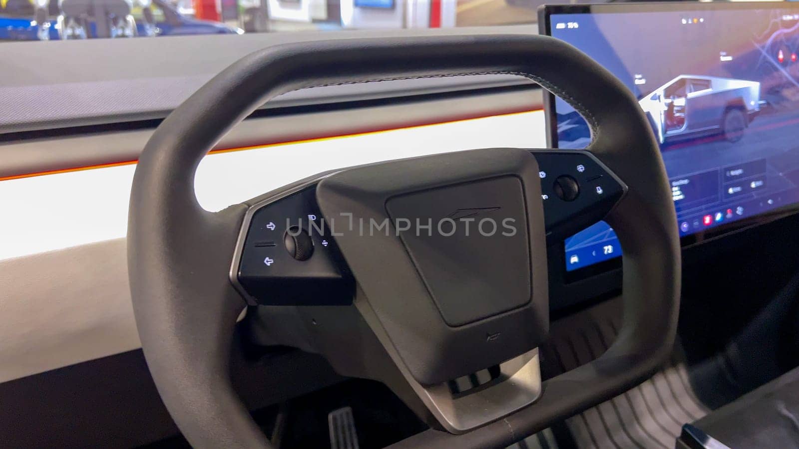 Colorado Springs, Colorado, USA-March 23, 2024-The futuristic Tesla Cybertruck takes center stage in the showroom of a Tesla store, with interested visitors and sleek car designs in the backdrop, all within the Park Meadows Mall.