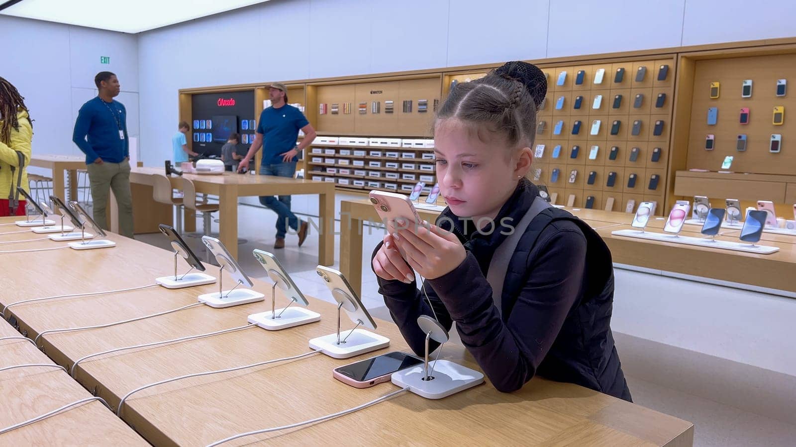 Little Girl Exploring New iPhones at Apple Store in Park Meadows Mall by arinahabich