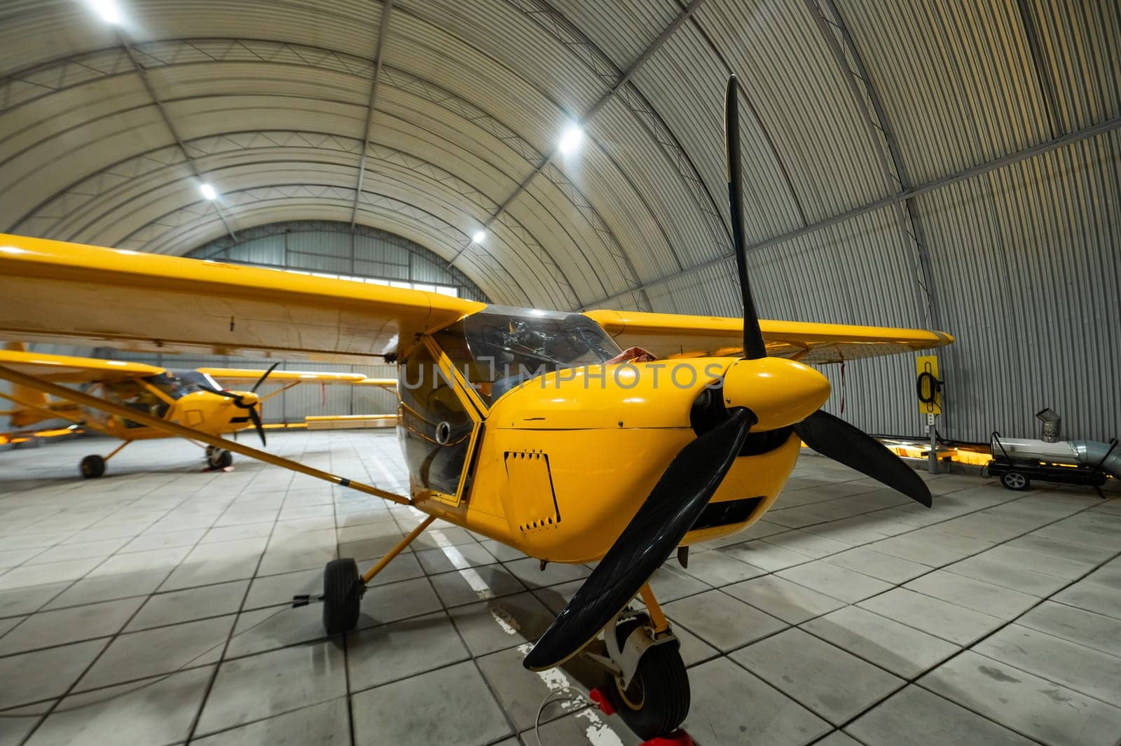 Yellow airplane glider in the hangar