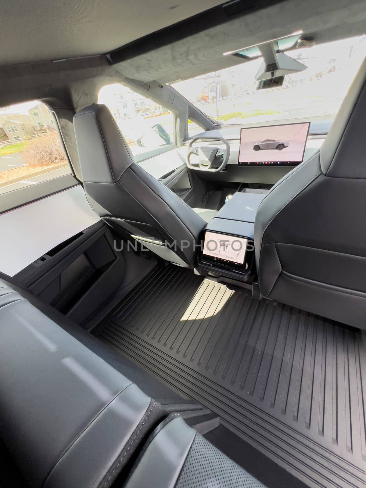 Denver, Colorado, USA-March 28, 2024-The interior shot of the Tesla Cybertruck showcases the roomy rear cabin with its modern, streamlined seats and durable flooring, reflecting the blend of utility and design.