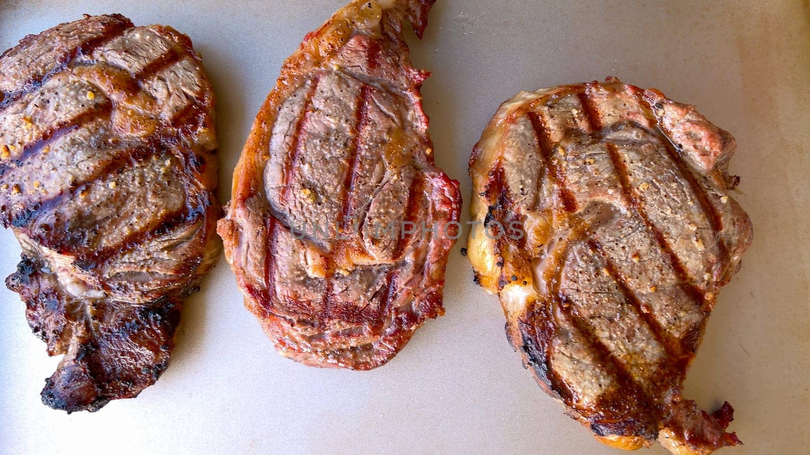 Grilled Ribeye Steaks with Perfect Char Marks Ready to Serve by arinahabich