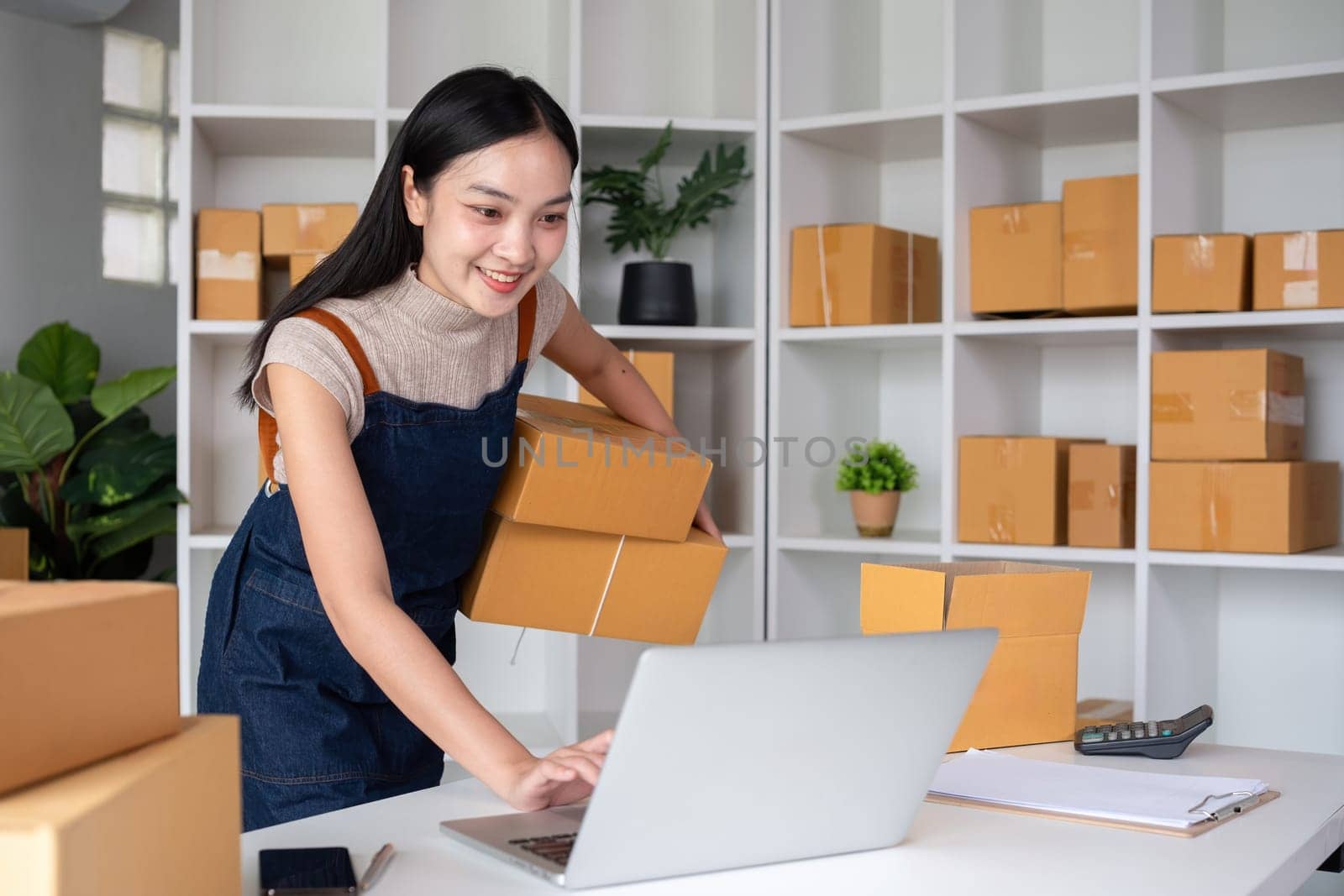 SME business entrepreneurs small in asia Preparing cardboard boxes in home office Small business operators preparing to ship to customers by wichayada