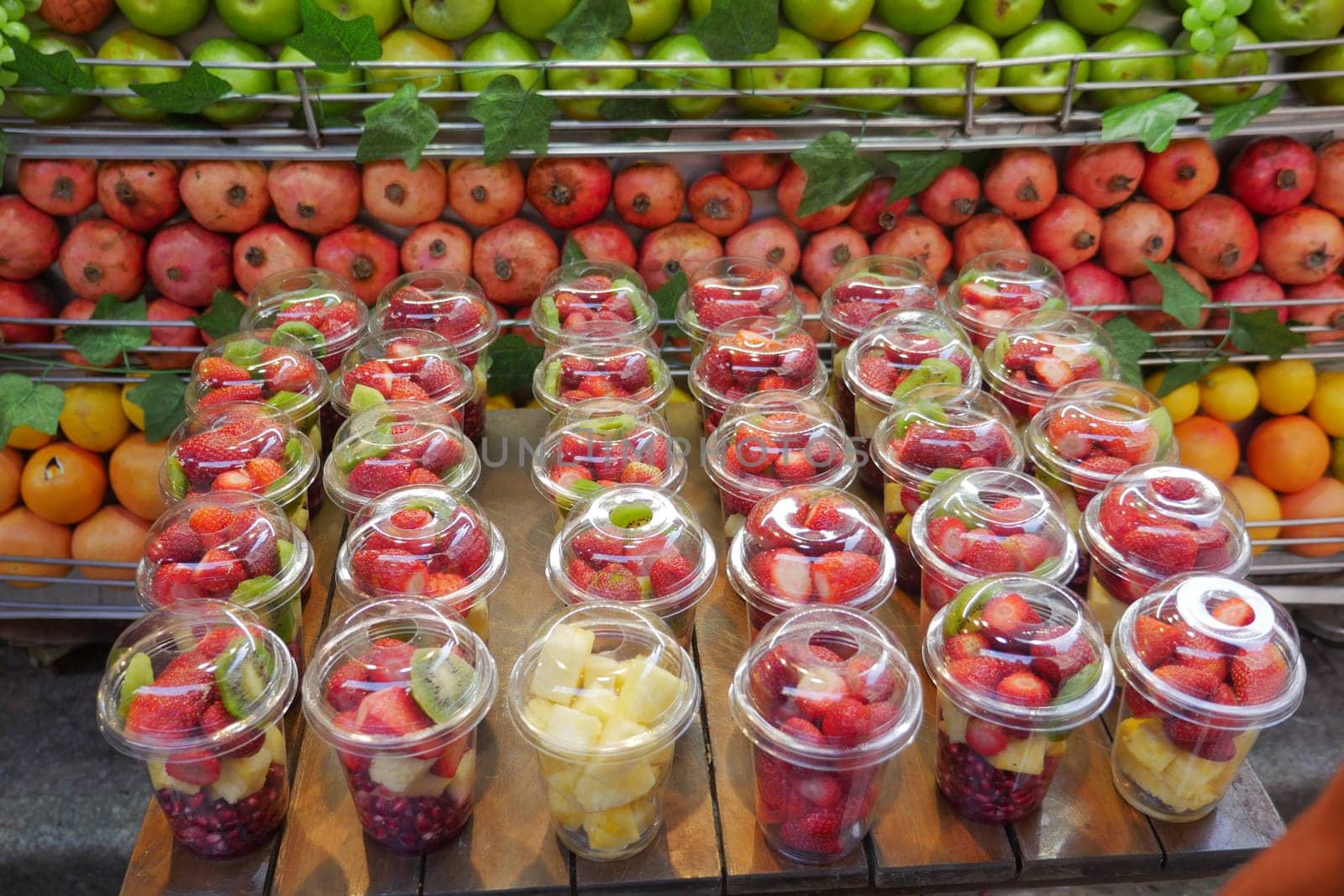 pineapple, kiwi and Strawberries in. plastic container selling at shop by towfiq007