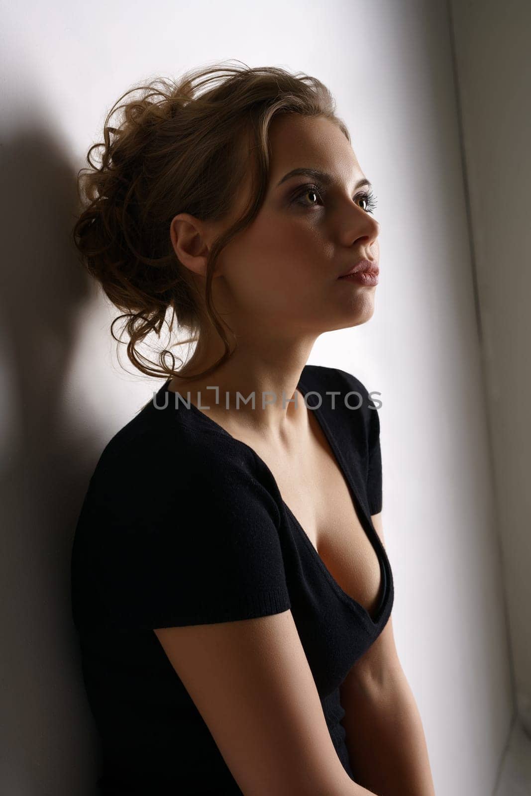 Studio portrait of beautiful girl wearing black casual dress