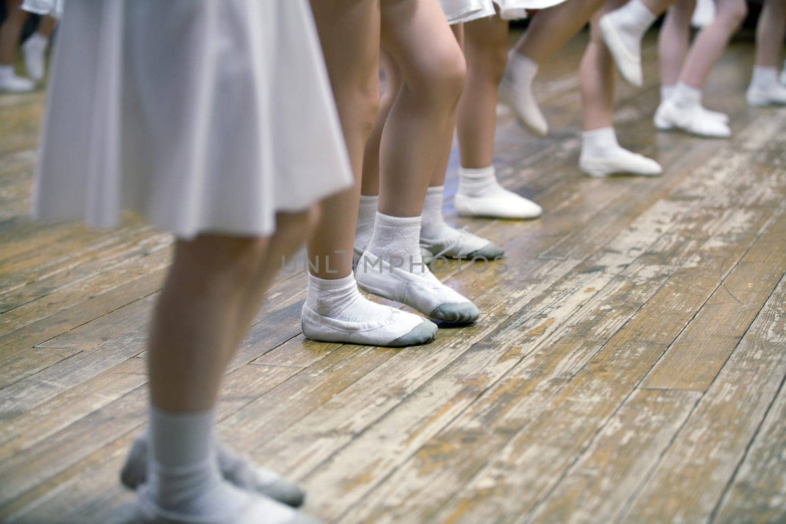 Young girls in ballet school. Image of legs, close-up