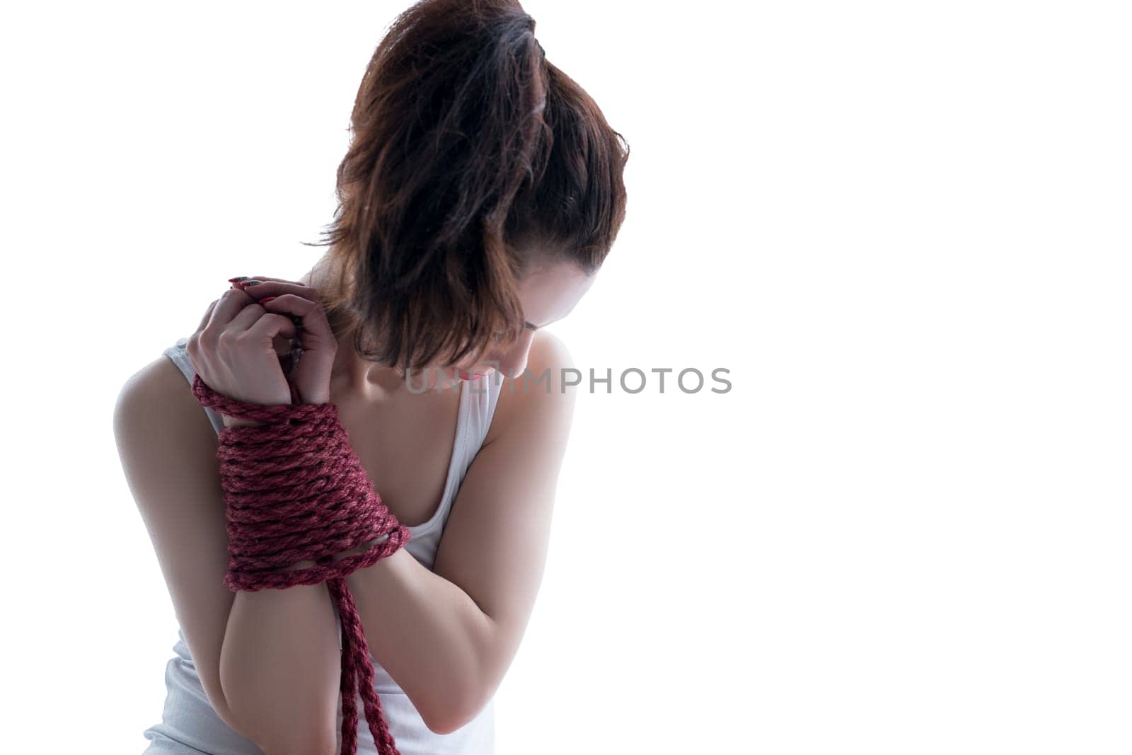 Image of dark-haired woman posing with hands bound