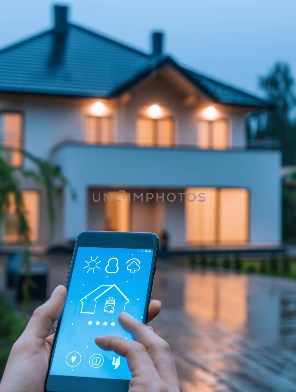 A person holding a smartphone showcasing an app interface with a modern house in the background