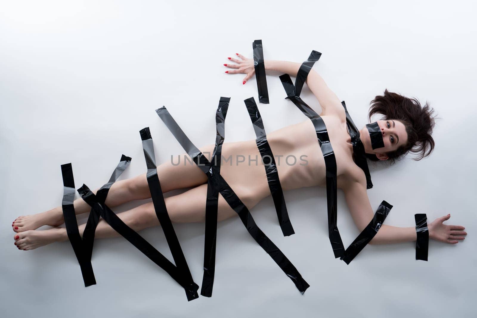 Censorship concept. Naked woman with black tape on her body