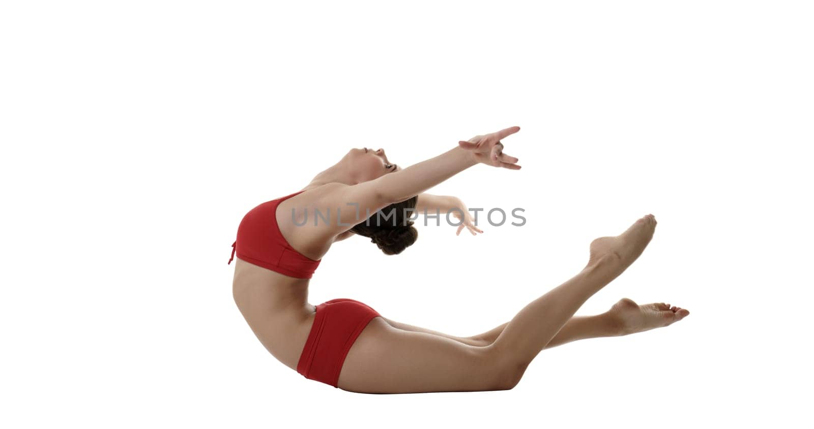 Lovely female gymnast arched her back at camera. Isolated on white