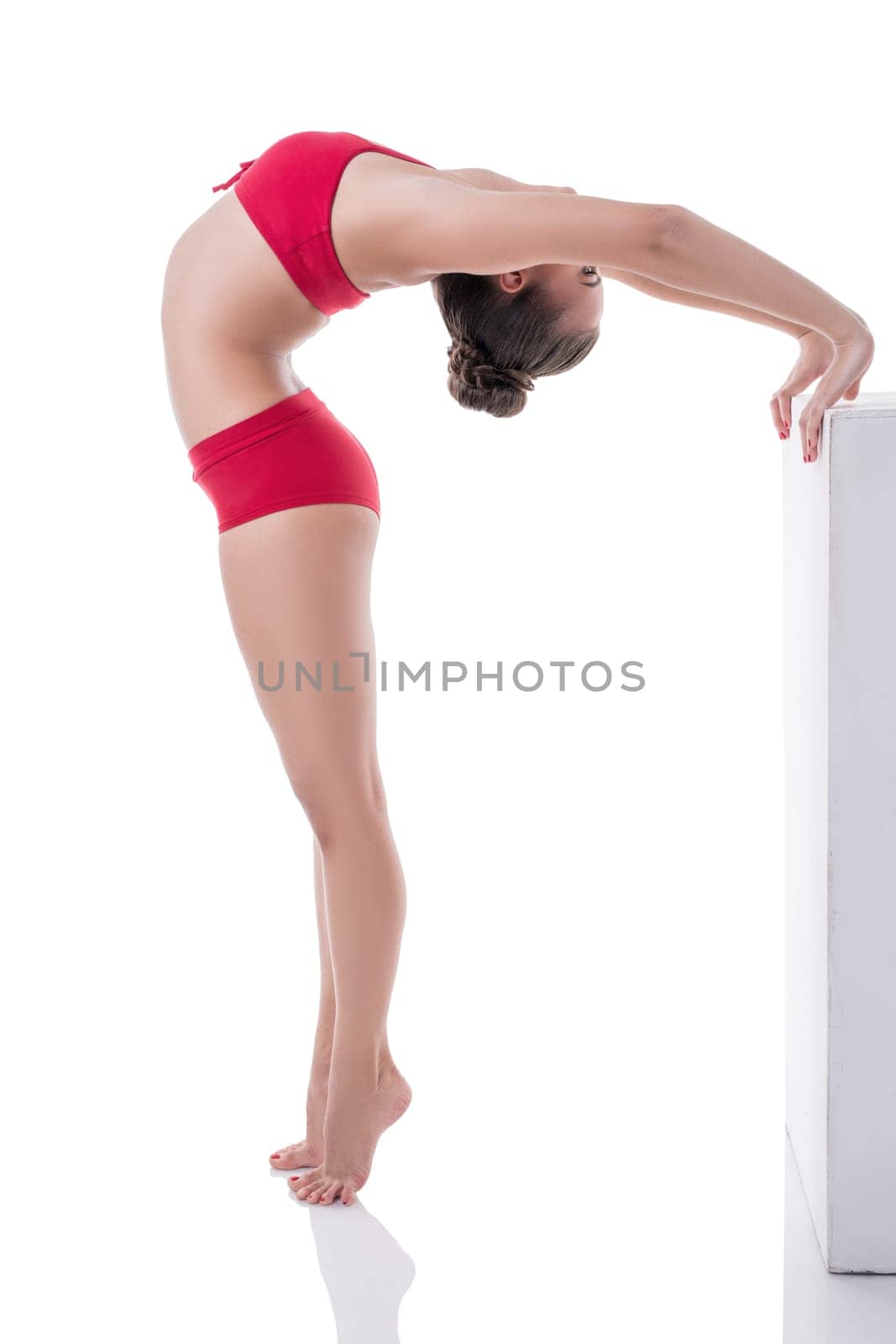 Lovely gymnast arched her back while standing on tiptoe