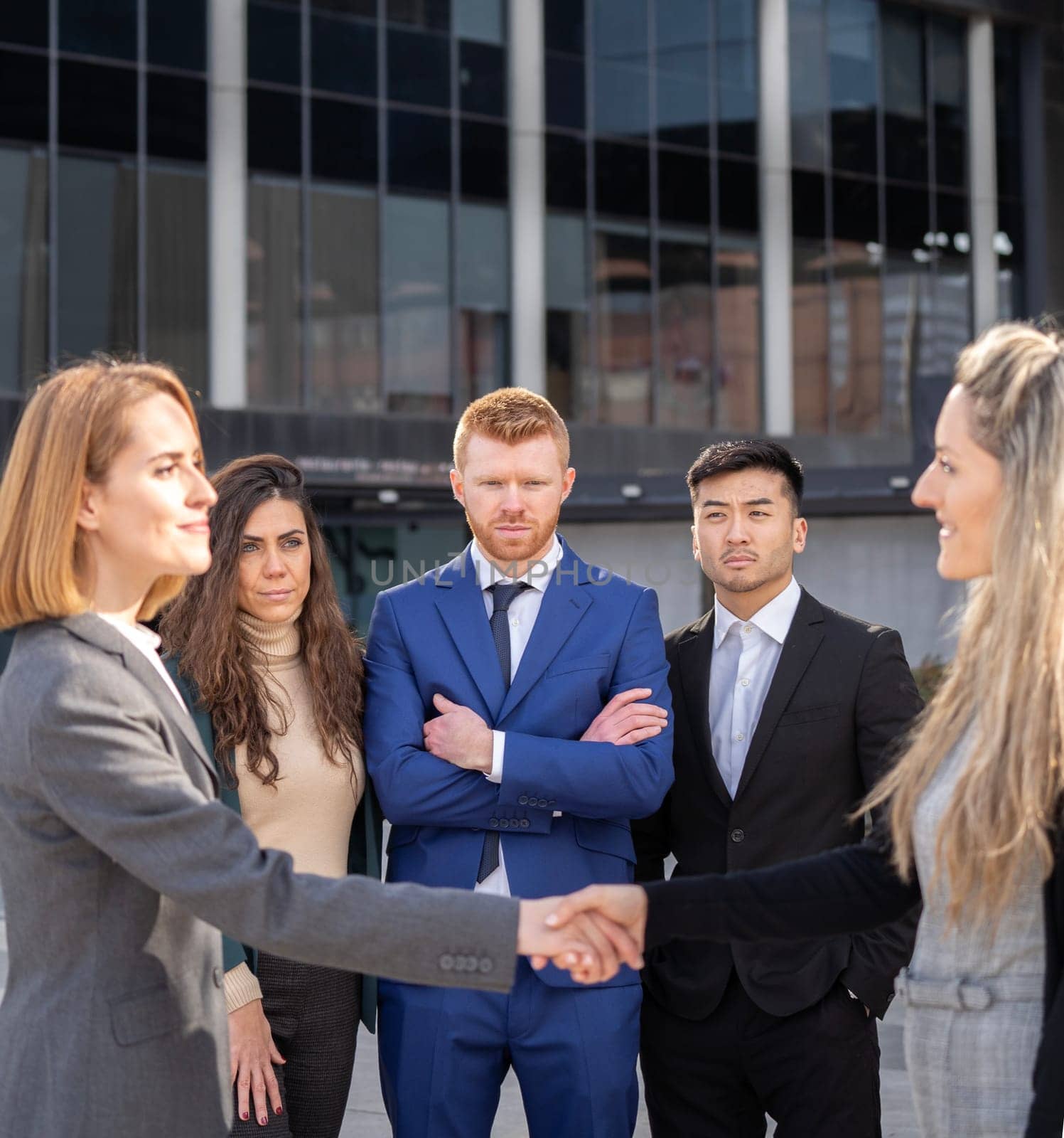 Group of multiracial business people shaking hands for a successful agreement by papatonic