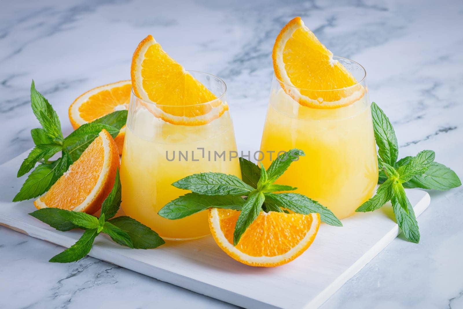 Glass of orange juice with ice. Cold orange fresh. Glass of orange juice by NataliPopova
