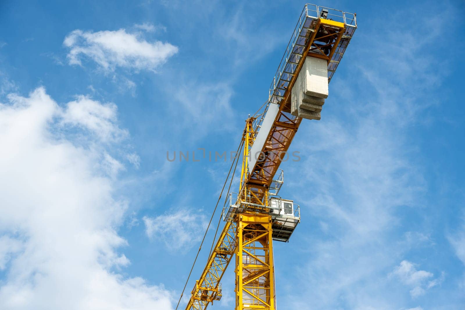 Construction crane working on large construction site by Sonat