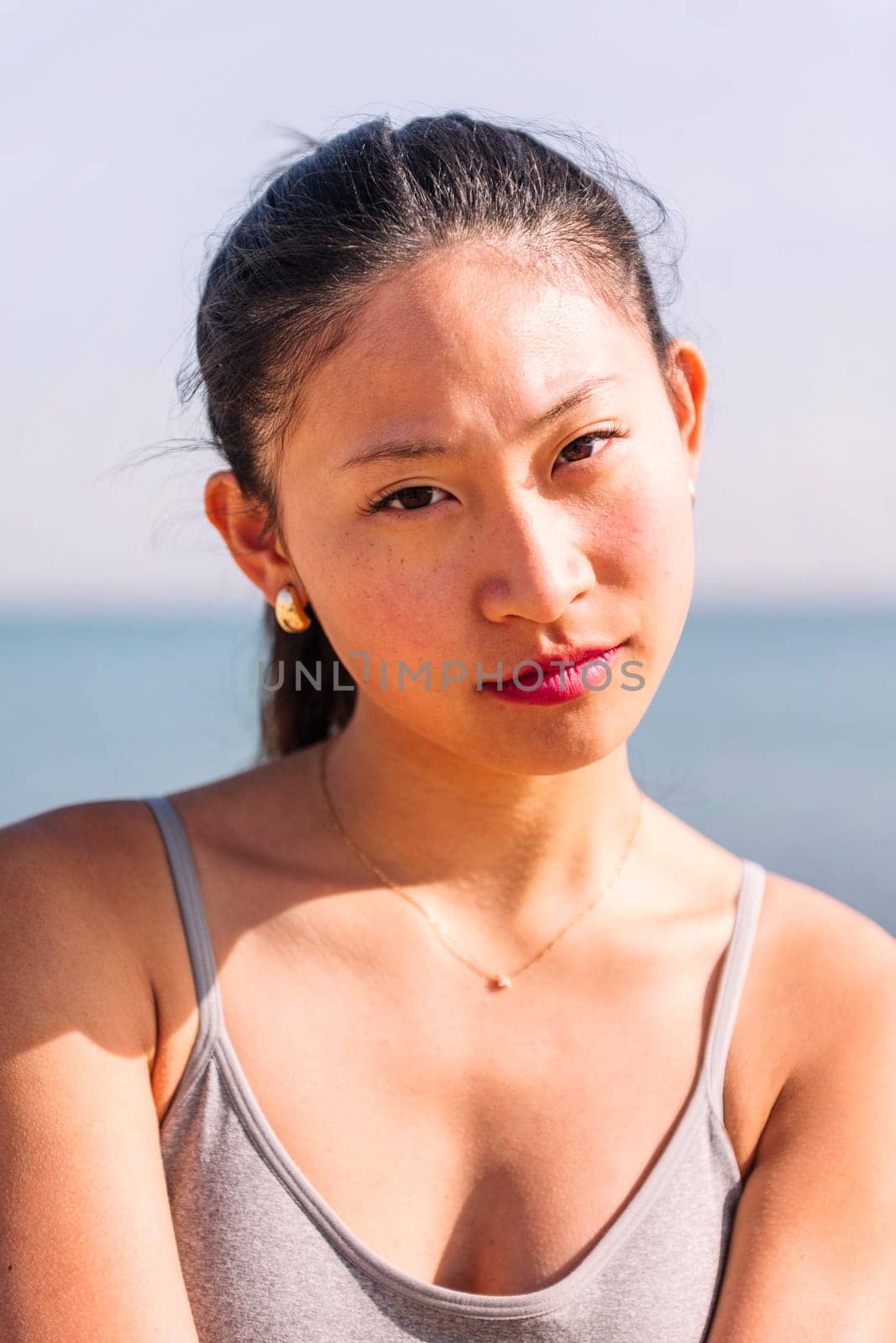half portrait of a young asian woman smiling happy by raulmelldo