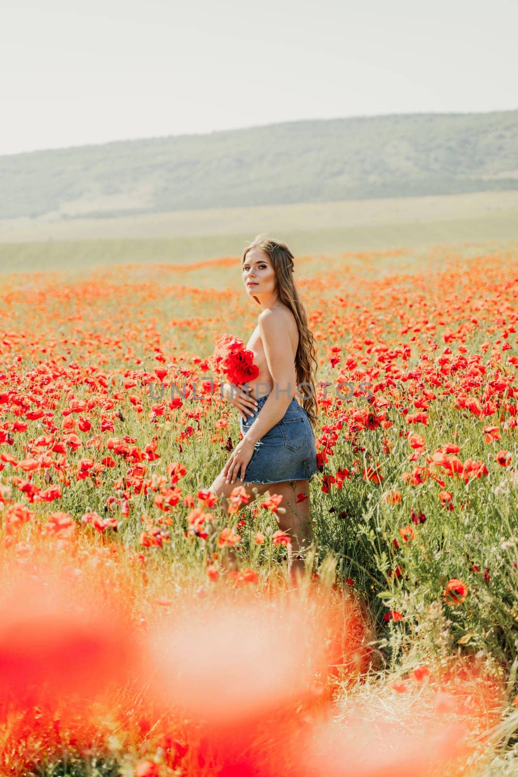 Woman poppies field. portrait happy woman with long hair in a poppy field and enjoying the beauty of nature in a warm summer day. by Matiunina