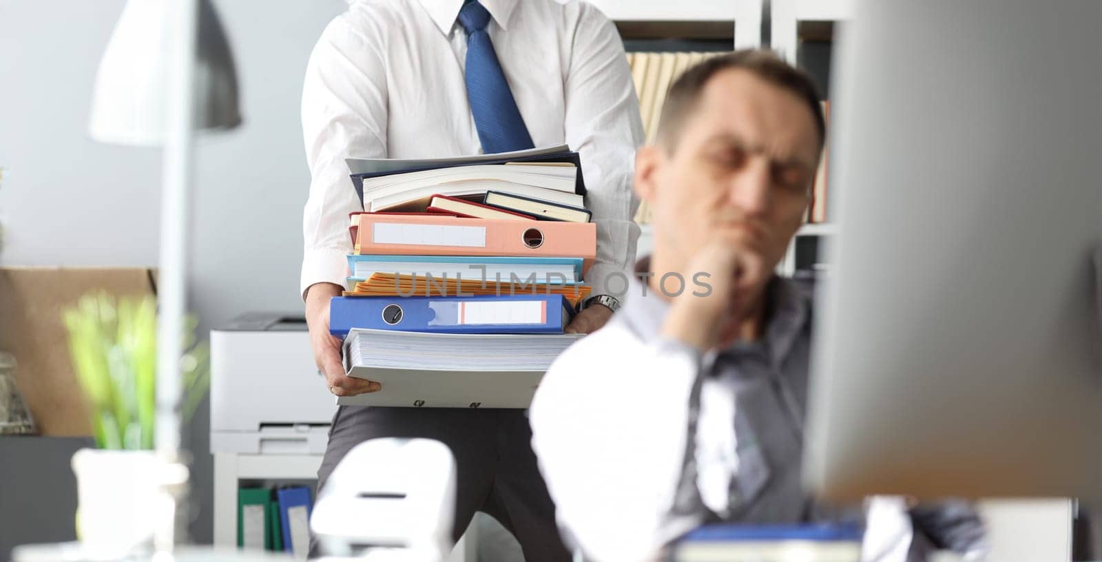 Man carrying big pile of documents to unhappy colleague by kuprevich