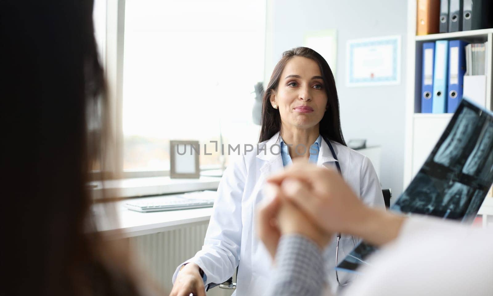 Doctor office at patient reception barely holds back laugh portrait. Tell me whats serious happened to you concept. Strange behavior medical service staff