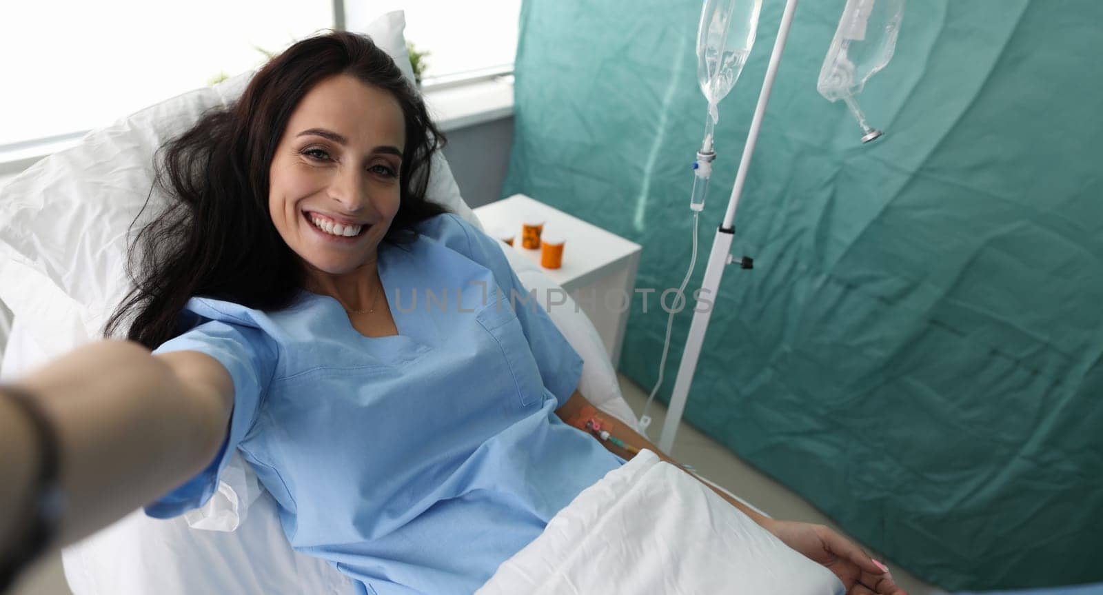 Beauty woman make selfie photo in hospital ward portrait. Social media addict concept