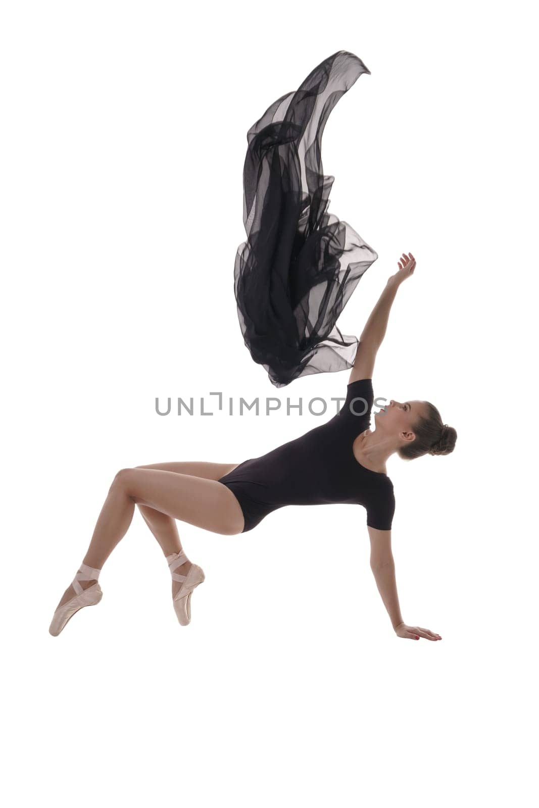 Studio image of artistic ballerina dancing with cloth