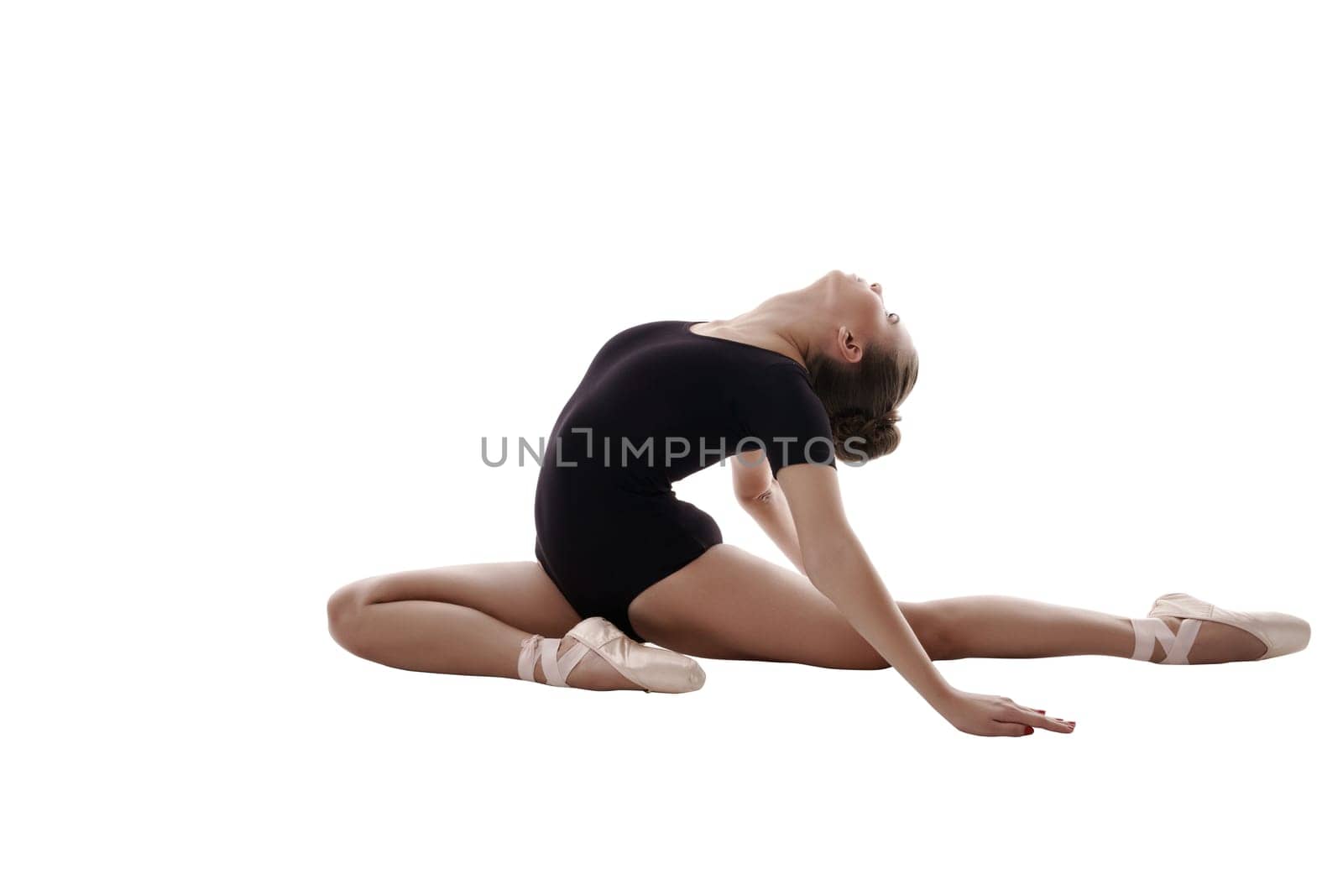 Ballet. Studio photo of flexible dancer doing splits