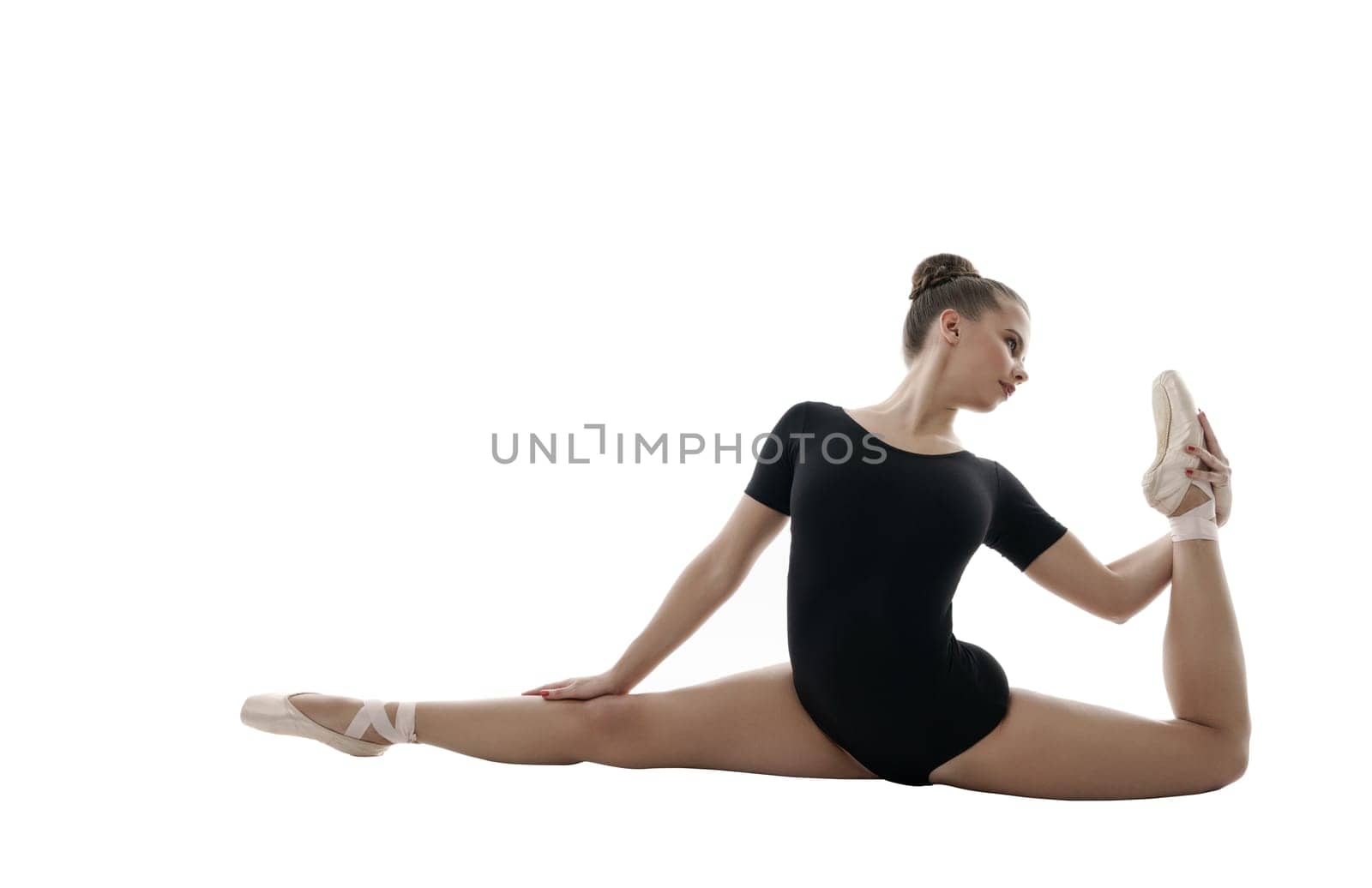 Ballet. Beautiful girl poses during rehearsal, isolated on white