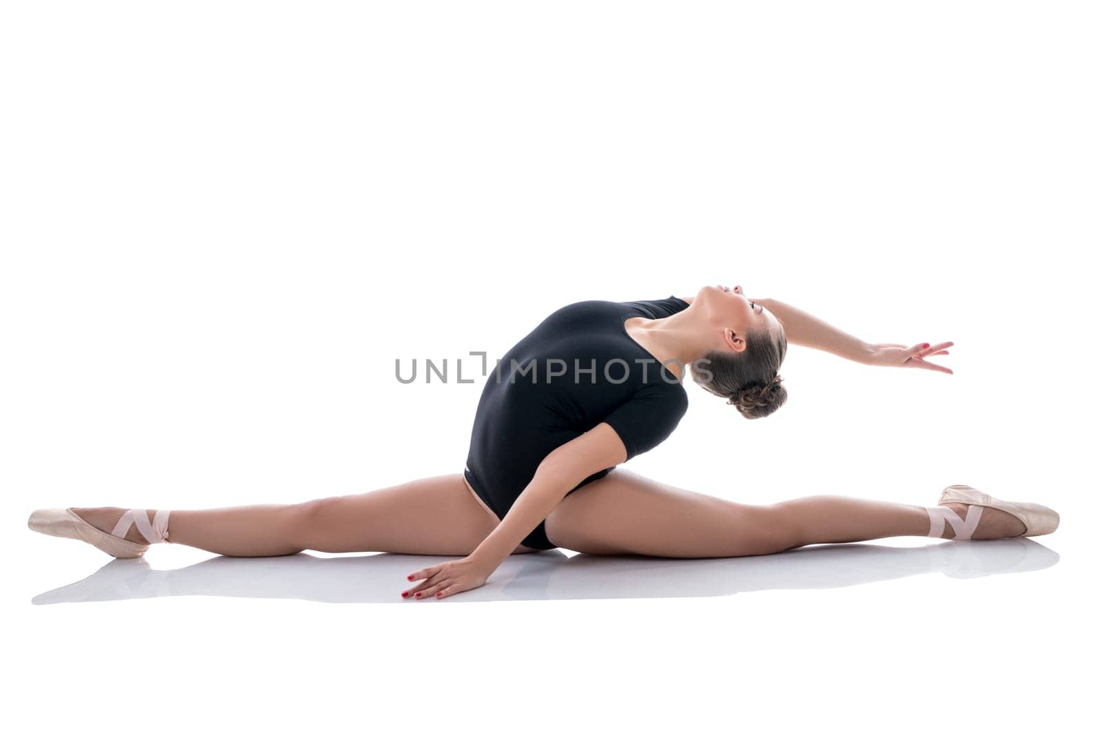 Image of pretty ballerina gracefully performs splits