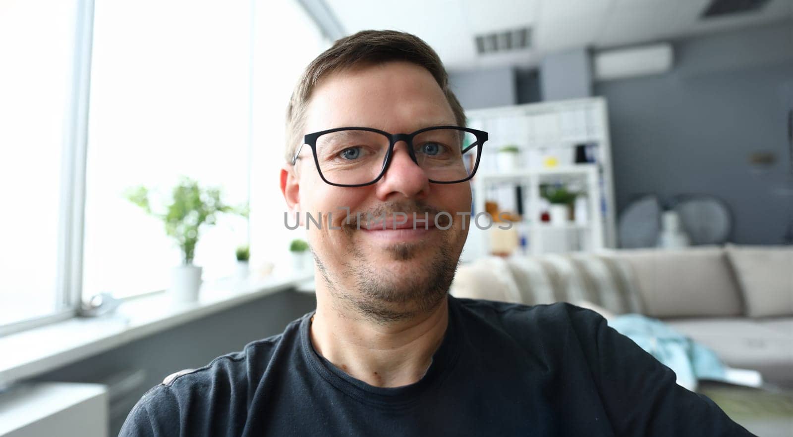 Handsome adult caucasian man make self photo against office background. Happy lifestyle concept