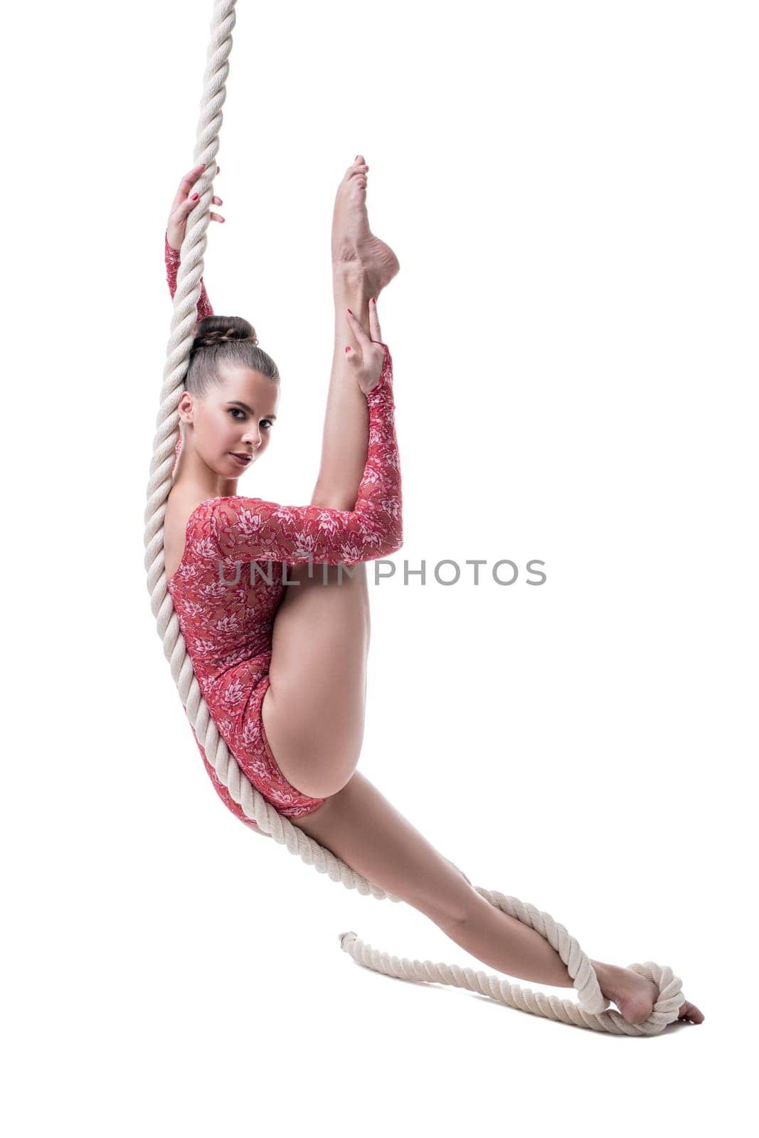 Image of charming barefoot girl posing hanging on rope