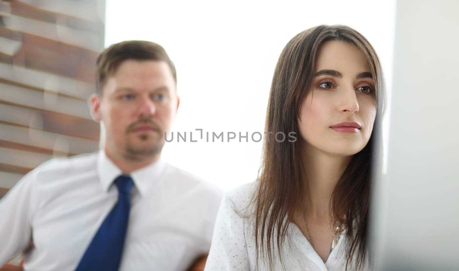 Two coworkers looking at computer pc screen analysing something headshot