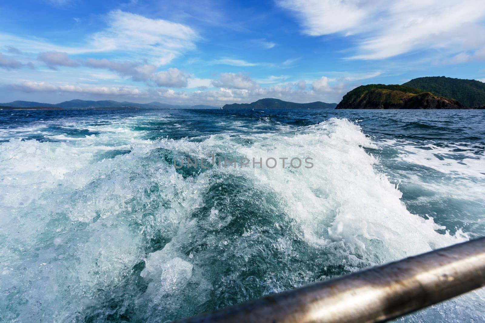 Seascape while boating. Image of sea foam on waves. Thailand